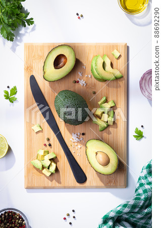 Flat lay composition with fresh avocados on wooden base. Vertical format. Flat lay composition with fresh avocados on wooden base. Vertical format. 88692290