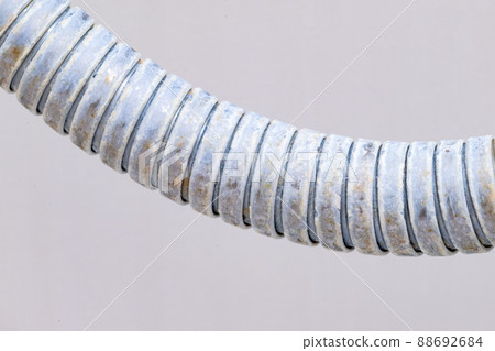 Close-up on shower hose with limescale. Calcification of a shower hose in bathroom. 88692684