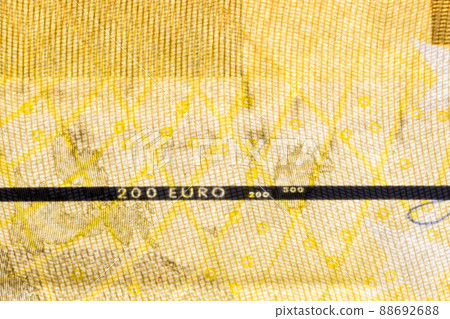 Close-up on vertically plastic security strip inside 200 EURO banknote. Close-up on vertically plastic security strip inside 200 EURO banknote. 88692688