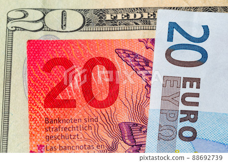 Close-up of the number 20 on USD, CHF and EUR banknotes. Detail of US dollar, euro and Swiss franc. Close-up of the number 20 on USD, CHF and EUR banknotes. Detail of US dollar, euro and Swiss franc. 88692739