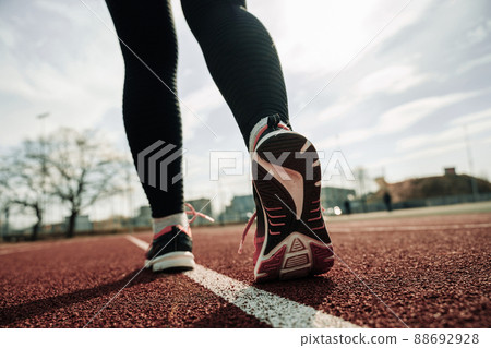 Sport running woman exercise. Runner feet running on road closeup on shoe. Run female workout exercise. Sport and healthy lifestyle. 88692928