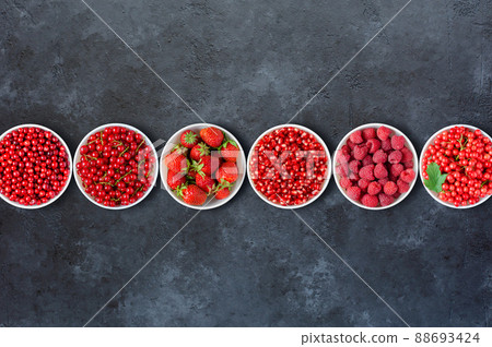 Berries in plates on a black concrete background. Copy space. Flat top view. 88693424
