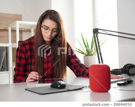 young woman working at home on desktop pc and digital tablet young woman working at home on desktop pc and digital tablet 88694050