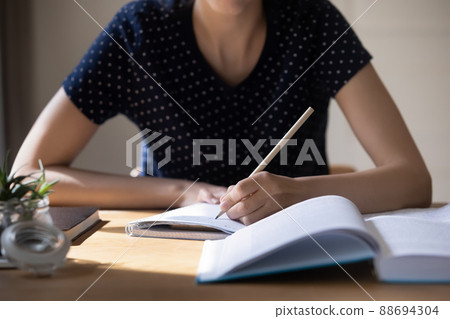Unknown woman studying, writing notes, prepare for exam Unknown woman studying, writing notes, prepare for exam 88694304
