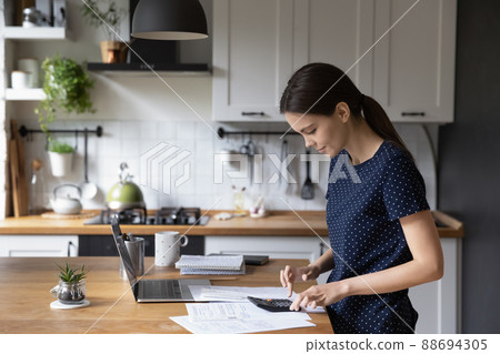 Woman calculate expenses, makes personal finances analysis Woman calculate expenses, makes personal finances analysis 88694305