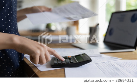 Female accountant hand makes calculations, closeup bills and calculator 88694331