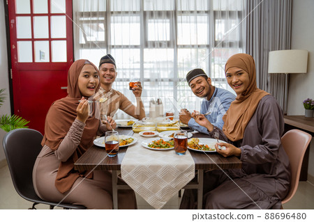 asian muslim friend and family break fasting together 88696480