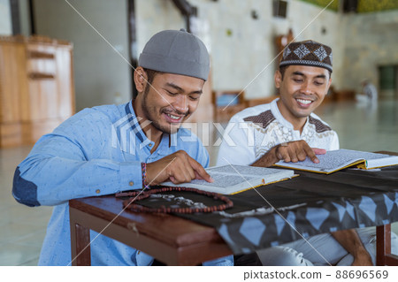 asian Man muslim reading quran together during ramadan at the mosque asian Man muslim reading quran together during ramadan at the mosque 88696569