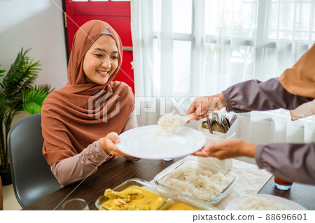 serving food for friend for iftar dinner or eid mubarak serving food for friend for iftar dinner or eid mubarak 88696601