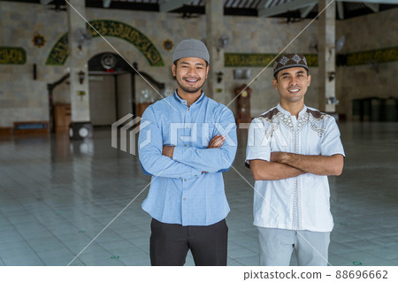 muslim at the mosque looking at the camera crossed their arm 88696662