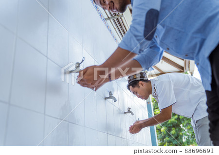 Man muslim perform ablution or wudu at the mosque 88696691