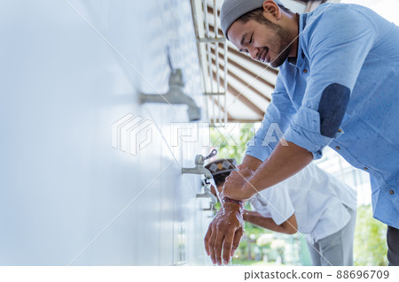 Man muslim perform ablution or wudu at the mosque 88696709