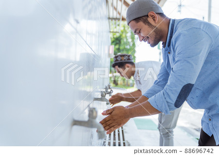 Man muslim perform ablution or wudu at the mosque 88696742