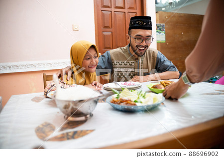 muslim father and daughter during iftar dinner on ramadan kareem 88696902