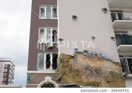 2022 Russian invasion Ukraine war Bucha destroyed building destruction wall hole shot Irpin aftermath shell of civilian hitting city Bucha damage building destruction. Terror attack Russia war concept 2022 Russian invasion Ukraine war Bucha destroyed building destruction wall hole shot Irpin aftermath shell of civilian hitting city Bucha damage building destruction. Terror attack Russia war concept 88698450