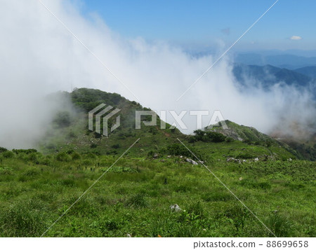 Mountain swallowed by clouds 88699658