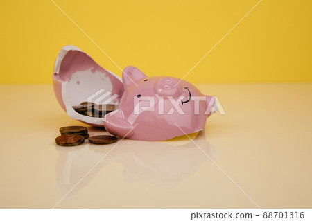 Broken piggy bank with coins Broken piggy bank with coins 88701316