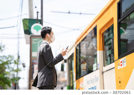 Businessman earphone bus stop bus Businessman earphone bus stop bus 88702061