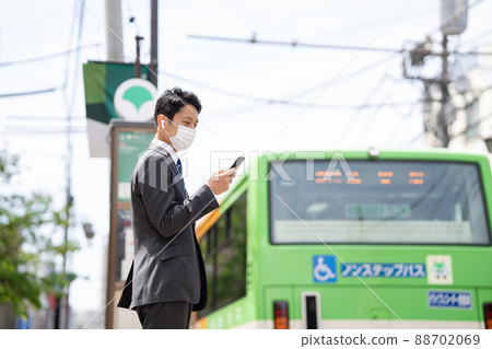 Businessman earphone bus stop bus 88702069