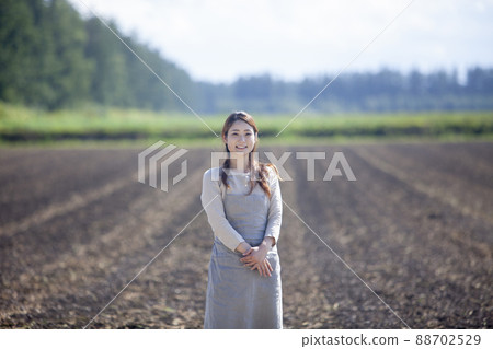Farmer woman, spring field Farmer woman, spring field 88702529