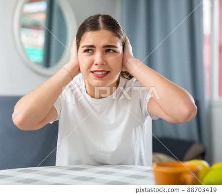 Screaming displeased young woman splashing out emotions 88703419