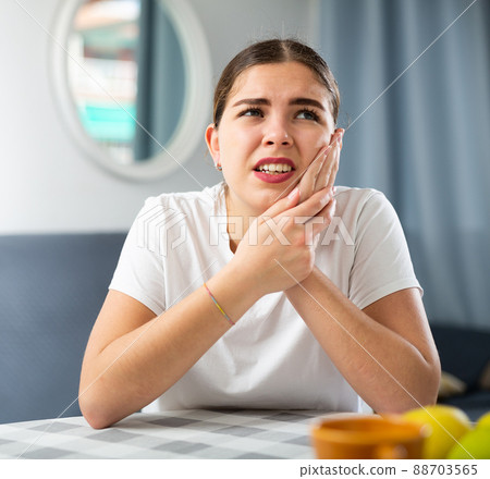 Portrait of a young girl suffering from toothache Portrait of a young girl suffering from toothache 88703565