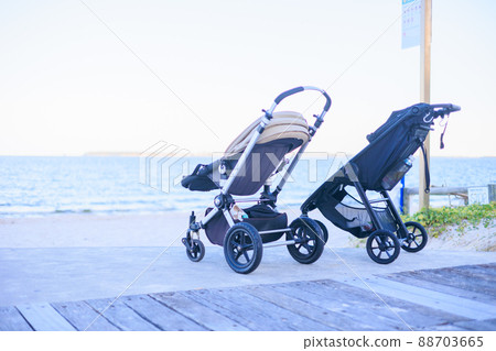 Stroller placed on the beach Stroller placed on the beach 88703665