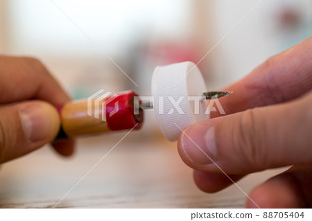 Make a hole in the PET bottle cap with a cone Make a hole in the PET bottle cap with a cone 88705404