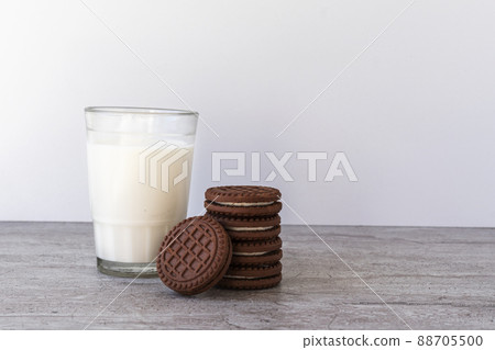 Chocolate chip cookies with milk on a light background. Chocolate sandwich - cookies. Chocolate chip cookies with milk on a light background. Chocolate sandwich - cookies. 88705500