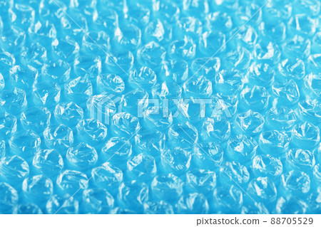 Packing bubble wrap for parcels on a blue background in full screen Packing bubble wrap for parcels on a blue background in full screen 88705529