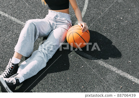 Close-up of a girl with a basketball on a sports field or a school stadium 88706439