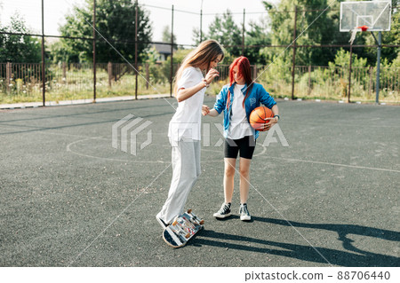 Two friends are learning to skate, the girls help each other and support each other. Friends, friendship, help 88706440