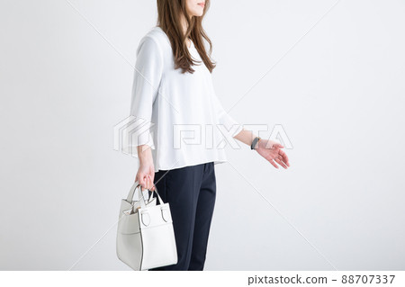 Female office lady standing with a handbag 88707337