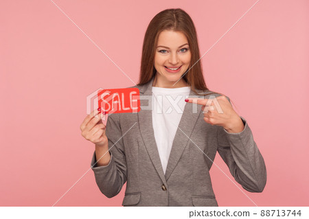 Holiday discounts for business client. Portrait of elegant lady boss in suit jacket pointing at Sale word, promoting low cost, best price products, Black Friday shopping. indoor studio shot isolated Holiday discounts for business client. Portrait of elegant lady boss in suit jacket pointing at Sale word, promoting low cost, best price products, Black Friday shopping. indoor studio shot isolated 88713744