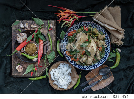 Green curry with Chicken and Thai eggplants (Kaeng khiao wan) in Ceramic bowl served with Rice noodles. Green curry with Chicken and Thai eggplants (Kaeng khiao wan) in Ceramic bowl served with Rice noodles. 88714541