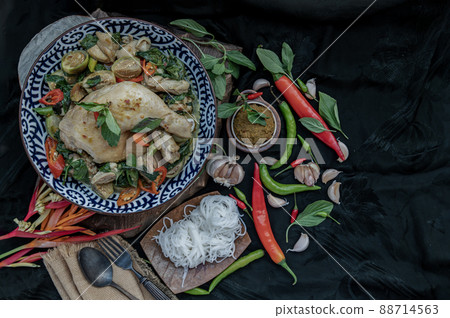 Green curry with Chicken and Thai eggplants (Kaeng khiao wan) in Ceramic bowl served with Rice noodles. Green curry with Chicken and Thai eggplants (Kaeng khiao wan) in Ceramic bowl served with Rice noodles. 88714563