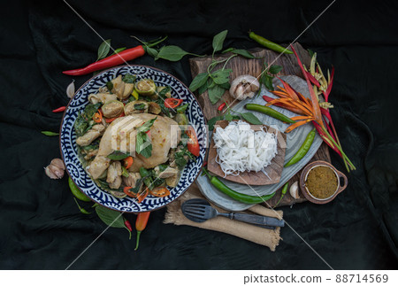 Green curry with Chicken and Thai eggplants (Kaeng khiao wan) in Ceramic bowl served with Rice noodles. Green curry with Chicken and Thai eggplants (Kaeng khiao wan) in Ceramic bowl served with Rice noodles. 88714569