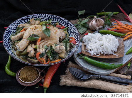 Green curry with Chicken and Thai eggplants (Kaeng khiao wan) in Ceramic bowl served with Rice noodles. Green curry with Chicken and Thai eggplants (Kaeng khiao wan) in Ceramic bowl served with Rice noodles. 88714571