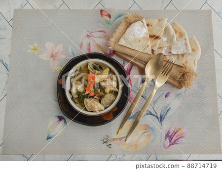 Homemade pita bread served with Green curry chicken. Homemade pita bread served with Green curry chicken. 88714719