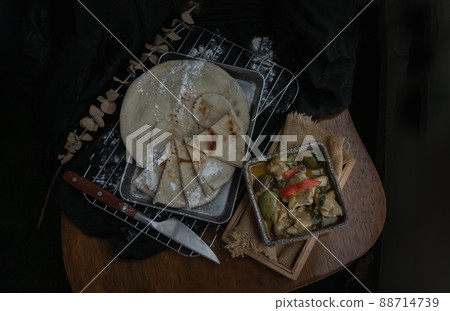 Homemade pita bread served with Green curry chicken (Kaeng khiao wan). Homemade pita bread served with Green curry chicken (Kaeng khiao wan). 88714739