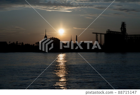 Gorgeous scenic of Thai temple silhouettes and Industrial factory along Chao phraya river over sun at sunrise. 88715147