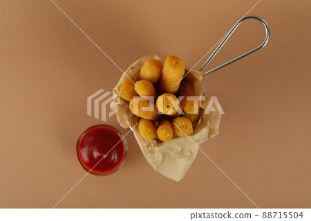 Cheese sticks and ketchup on brown background 88715504