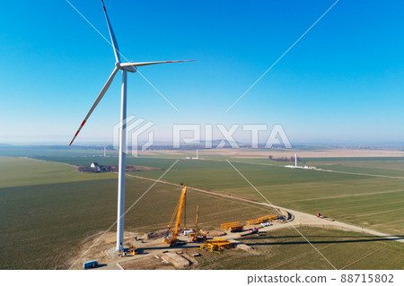 Installing new wind generator, Windmill turbine maintenance, Construction site with cranes for installing windmill tower, Wind power and renewable energy Installing new wind generator, Windmill turbine maintenance, Construction site with cranes for installing windmill tower, Wind power and renewable energy 88715802