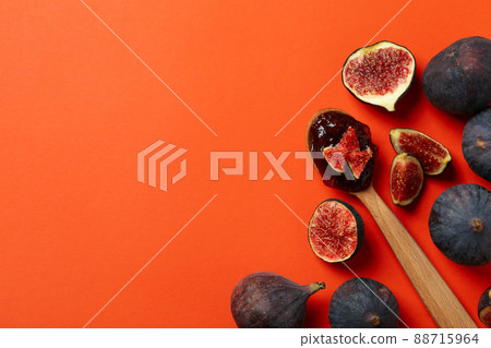Spoon with fig jam and ingredients on orange background 88715964