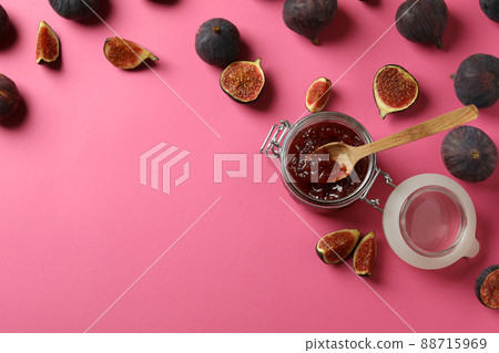 Jar with fig jam and spoon, and ingredients on pink background Jar with fig jam and spoon, and ingredients on pink background 88715969
