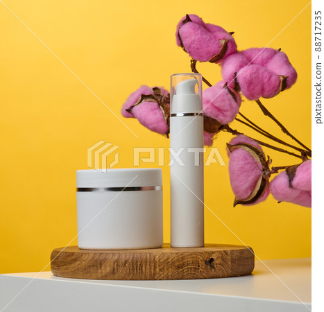 Empty white plastic tubes and jars for cosmetics. Packaging for cream, gel, serum, advertising and product promotion Empty white plastic tubes and jars for cosmetics. Packaging for cream, gel, serum, advertising and product promotion 88717235
