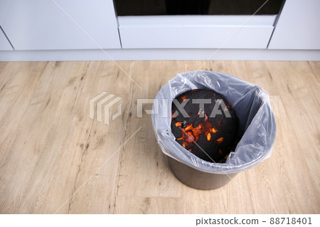 Burnt pie in the trash. 88718401