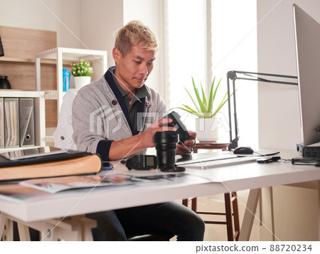 Graphic designer/photographer working in home office Graphic designer/photographer working in home office 88720234