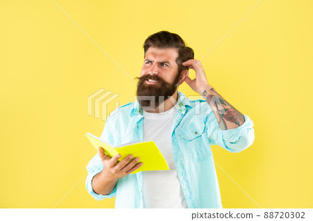 confused bearded man with planner on yellow background emotions confused bearded man with planner on yellow background emotions 88720302