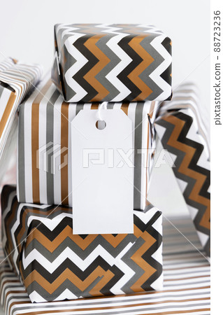 Wrapped present with blank vertical gift tag close up, label Mockup Wrapped present with blank vertical gift tag close up, label Mockup 88723236